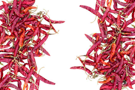 Dried red hot peppers isolated on white background, with copyspace in the middle. clipping path.の写真素材