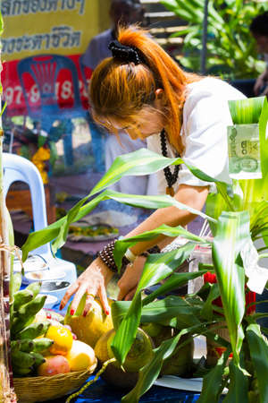 CHIANG RAI, THAILAND - SEPTEMBER 1 : unidentified hermit in tiger-skin cloth and a woman ritualising in front of altar table on September 1, 2016 in Chiang rai, Thailand.のeditorial素材
