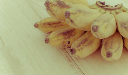 Pisang Awak banana, Kluai Nam Wa, Cultivate banana on wooden background, copyspace, vintage retro style.の写真素材