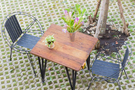 horizontal photo of Top view of table and two chairs with hole pattern floor.の写真素材