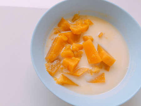 yellow pumpkin sliced in sweet coconut milk. Thai style dessert.の写真素材