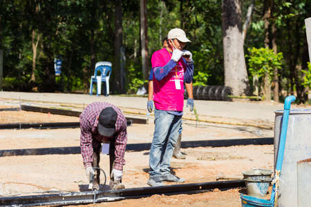 LAMPANG, THAILAND - NOVEMBER 5 : unidentified thai teenagers in working camp preparing the area for pouring concrete to make plaza on November 5, 2016 in Lampang, Thailand.のeditorial素材