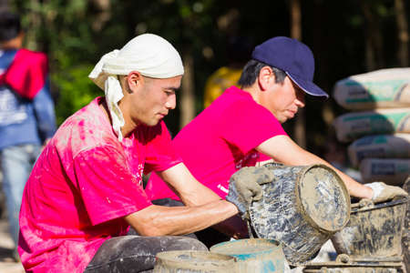 LAMPANG, THAILAND - NOVEMBER 5 : unidentified thai teenagers in working camp help villagers pouring concrete to make plaza on November 5, 2016 in Lampang, Thailandのeditorial素材