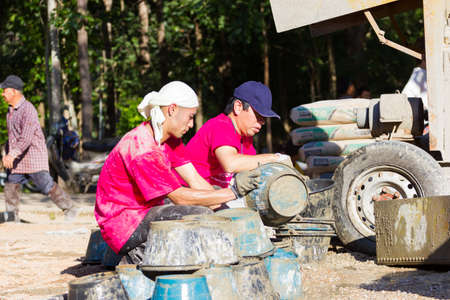 LAMPANG, THAILAND - NOVEMBER 5 : unidentified thai teenagers in working camp help villagers pouring concrete to make plaza on November 5, 2016 in Lampang, Thailandのeditorial素材
