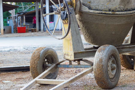 closeup the wheels of cement mixer on the construction site, horizontal photoの写真素材