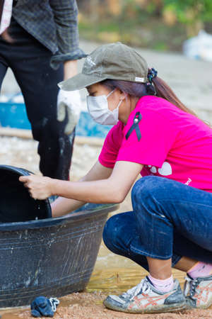 LAMPANG, THAILAND - NOVEMBER 5 : unidentified thai teenagers in working camp carrying water for mixing concrete to make plaza on November 5, 2016 in Lampang, Thailand.のeditorial素材