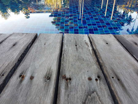 Close focus of edge of wood floor near swimming pool. perspective view.の写真素材