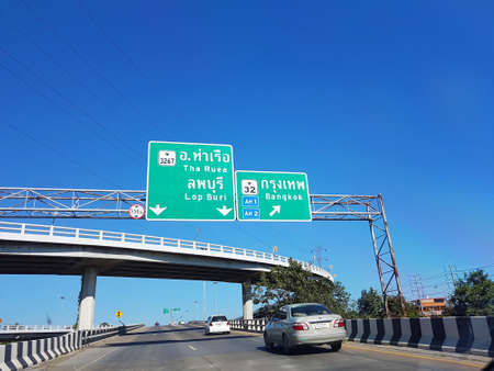 LOPBURI, THAILAND - NOVEMBER 27 : directional traffic sign on highway with clear blue sky on November 27, 2016 in Lopburi, Thailand.のeditorial素材