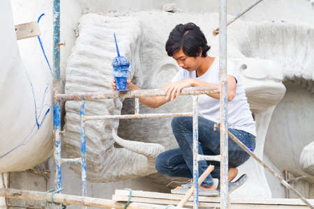 CHIANG RAI, THAILAND - FEBRUARY 12 : Unidentified man working creating big clay statues in Wat Rong Sua Ten temple on February 12, 2017 in Chiang rai, Thailand.のeditorial素材
