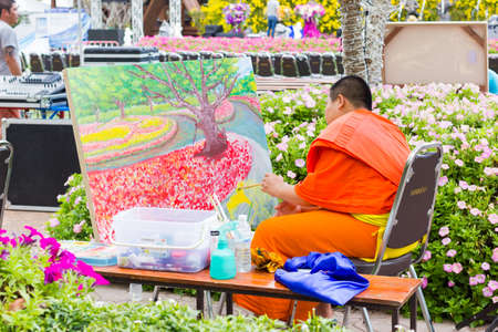 CHIANGRAI, THAILAND - DECEMBER 7: unidentified asian monk painting at flower festival on December 7, 2016 in Chiangrai, Thailand.のeditorial素材