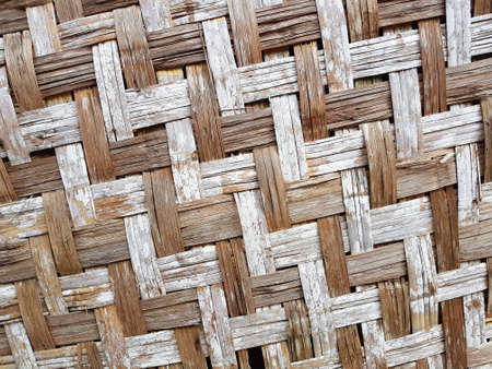 Pattern of old Thai house wall for background and texture. Made of bamboo plant stalks.の写真素材