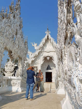 CHIANG RAI, THAILAND - MARCH 1 : Unidentified tourists taking photo or selfie Wat Rong Khun temple on March 1, 2017 in Chiang rai, Thailandのeditorial素材