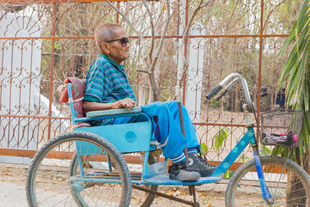CHIANG RAI, THAILAND - FEBRUARY 19 : Unidentified asian man suffering from leprosy on tricycle on February 19, 2016 in Chiang rai, Thailand.のeditorial素材
