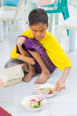 CHIANG RAI, THAILAND - FEBRUARY 19 : Unidentified old asian woman suffering from leprosy eating food on February 19, 2016 in Chiang rai, Thailand.のeditorial素材