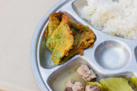 closeup stainless tray with rice, omelette and soup, shallow depth of field.の写真素材