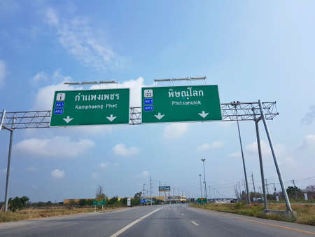 NAKHON SAWAN, THAILAND - MARCH 31 : directional traffic sign to Kamphaeng Phet and Phitsanulok on March 31, 2017 in Nakhon Sawan, Thailand.のeditorial素材
