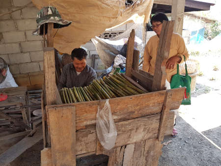 CHIANG RAI, THAILAND - MARCH 26 : unidentified man making the bamboo handle of native Thai grass broom in a factory on March 26, 2017 in Chiang rai, Thailand.のeditorial素材