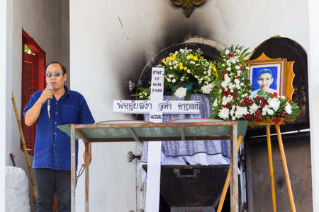 CHIANG RAI, THAILAND - APRIL 19 : unidentified asian man speaking next to the white cross and a...