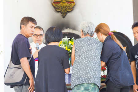 CHIANG RAI, THAILAND - APRIL 19 : unidentified asian old woman with her helpers waking up the steps at thai traditional Christian funeral on April 19, 2017 in Chiang rai, Thailand.のeditorial素材