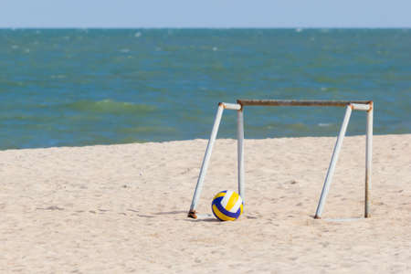 Portable iron soccer goal with yellow volleyball on the beach in Thailandの写真素材