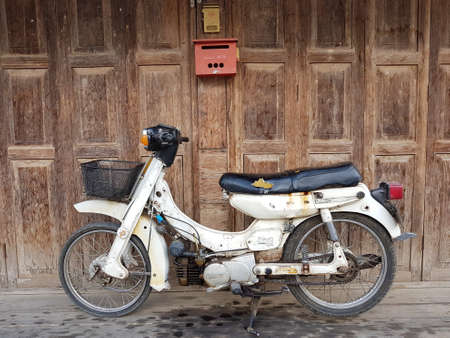 CHIANG RAI, THAILAND - MAY 6 : old Yamaha motorcycle on wooden door background on May 6, 2017 in Chiang rai, Thailand.のeditorial素材