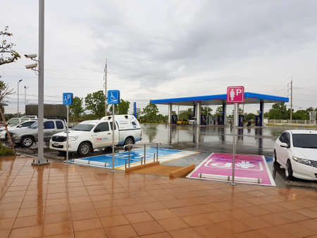 CHIANG RAI, THAILAND - MAY 8 : Lady parking sign and disabled sign after raining in gas station on May 8, 2017 in Chiang rai, Thailand.のeditorial素材