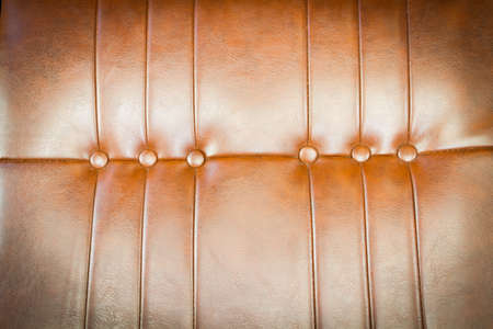 luxurious brown leather texture of sofa closeup shot. vintage retro styleの写真素材