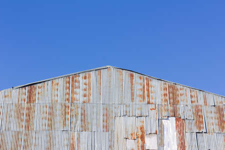 closeup old gable of the house made of rusty galvanized ironの写真素材
