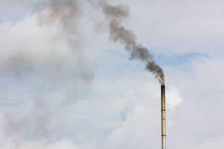 smoke from chimney on the cloudy sky, copyspace