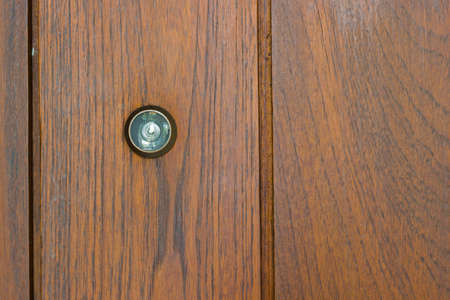 Peephole on the wooden door with copyspaceの写真素材