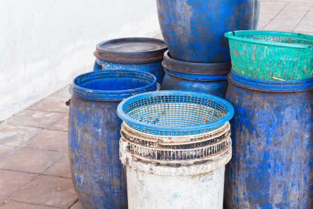 dirty white and blue garbage bin with copyspace on the left