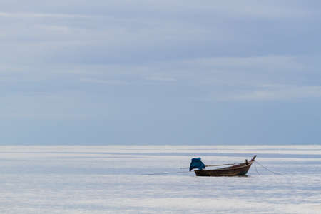 fishing boat floating on the sea backgroundの写真素材