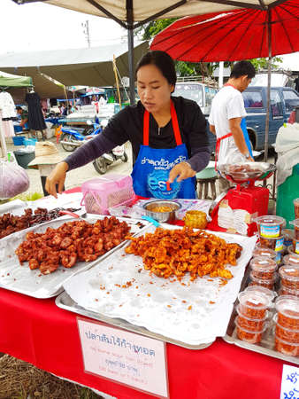 CHIANG MAI, THAILAND - SEPTEMBER 29 : Unidentified asian woman selling fried pork at street market in the evening on September 29, 2017 in Chiang Mai, Thailand.のeditorial素材