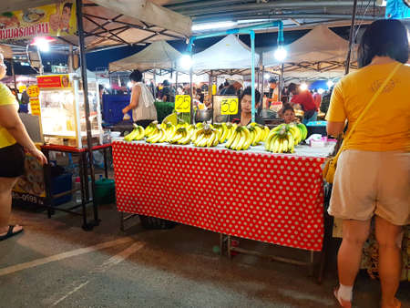 CHIANG MAI, THAILAND - SEPTEMBER 28 : Unidentified asian woman buying banana at street market in the evening on September 28, 2017 in Chiang Mai, Thailand.のeditorial素材