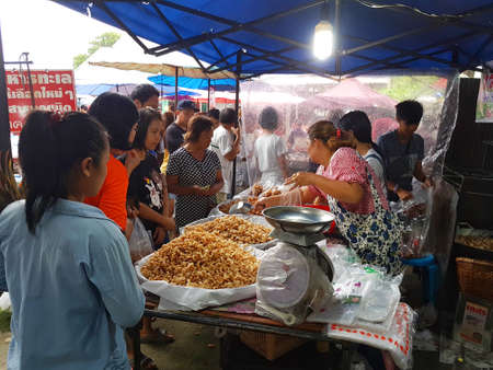 CHIANG MAI, THAILAND - SEPTEMBER 29 : Unidentified asian people selling crispy pork skin at street market in the evening on September 29, 2017 in Chiang Mai, Thailand.のeditorial素材