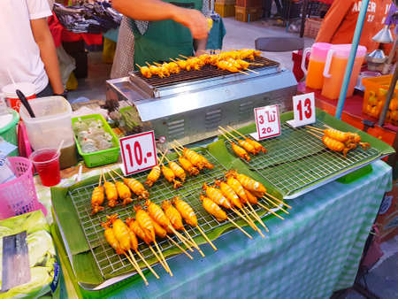 CHIANG MAI, THAILAND - SEPTEMBER 29 : grilled squid sold at street market in the evening on September 29, 2017 in Chiang Mai, Thailand.のeditorial素材