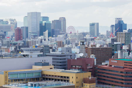 OSAKA, JAPAN - SEPTEMBER 18 : aerial view Osaka commercial and business cityscape at afternoon from top level of Osaka castle on September 18, 2017 in Osaka, Japan.のeditorial素材