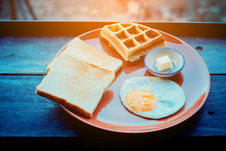 Breakfast set of hotel in Thailand on wooden table. Retro filter.の写真素材