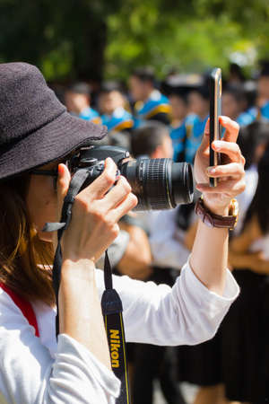 CHIANG RAI, THAILAND - OCTOBER 5 : unidentified asian woman taking photo with camera and smartphone at the same time on October 5, 2017 in Chiang rai, Thailand.のeditorial素材