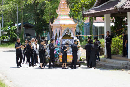 CHIANG MAI, THAILAND - MAY 19: Unidentified people in black clothes walking around the wooden palace of the dead body Thai traditional cremating ritual in countryside on May 19, 2018 in Chiang Mai, Thailand.のeditorial素材