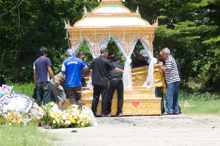 CHIANG MAI, THAILAND - MAY 19: close-up unidentified people put the coffin into the wooden palace ...