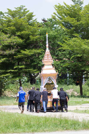 CHIANG MAI, THAILAND - MAY 19: Wide shot unidentified people moving the palace to the burning place...
