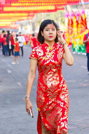 NAKHON SAWAN, THAILAND - FEBRUARY 8 : unidentified asian woman with Chinese costume standing in Chinese New Year festival on February 8, 2019 in  Nakhon Sawan, Thailand.のeditorial素材