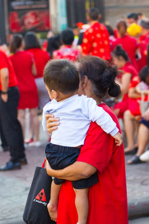 NAKHON SAWAN, THAILAND - FEBRUARY 8 : unidentified asian mother holding her son in Chinese New Year festival on February 8, 2019 in  Nakhon Sawan, Thailand.のeditorial素材