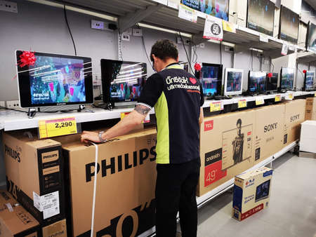 CHIANG RAI, THAILAND - JANUARY 2 : unidentified asian man selling digital television set in...