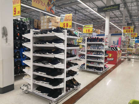 CHIANG RAI, THAILAND - NOVEMBER 21 : black shoes sold on supermarket display shelf on November 21, 2019 in Chiang Rai, Thailand.のeditorial素材
