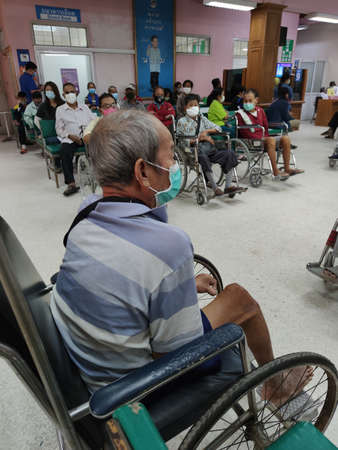 CHIANG RAI, THAILAND - MARCH 23 : Unidentified disabled asian old patient using hygienic mask in Phan hospital during the spread of Covid-19 virus on March 23, 2020 in Chiang Rai, Thailand.のeditorial素材
