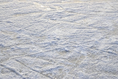 Skate marks on the surface of an outdoor ice rink 