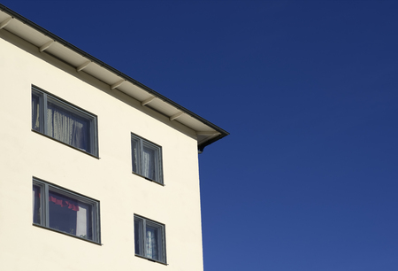 Closeup modern apartment building against blue sky.のeditorial素材