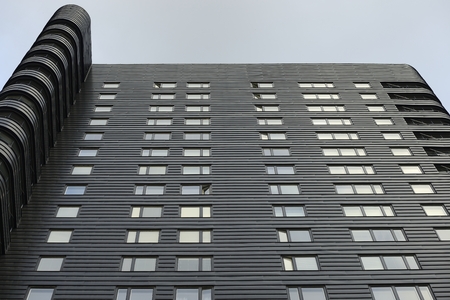 Closeup modern apartment building against blue skyのeditorial素材
